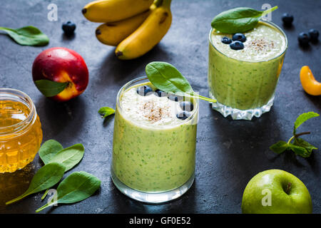 Green smoothie, detox smoothies in glass with blueberries, baby spinach, yogurt and chia seeds Stock Photo