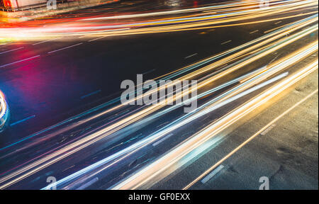 Colorful long exposure light trails across road junction, traffic concept or speed abstract Stock Photo