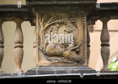 Lion eating a killed horse at the battlefield during the Conquest of Tunis by the Habsburg Empire of Charles V in 1535. Renaissance relief on the Summer Palace of Queen Anna in the Royal Garden of Prague Castle in Prague, Czech Republic. Stock Photo