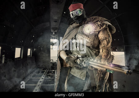 Futuristic soldier posing with gun and armor Stock Photo