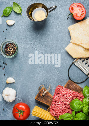 Ingredients for cooking pasta Bolognese on grey concrete background, top view Stock Photo