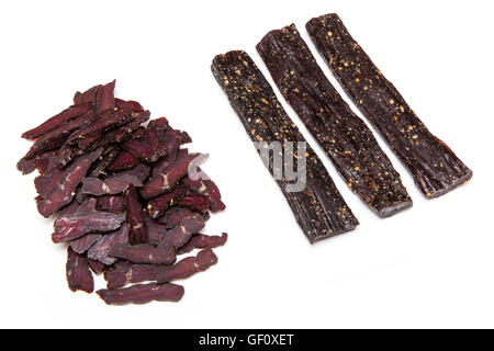 South African beef biltong or jerky whole and sliced isolated on a white studio background. Stock Photo