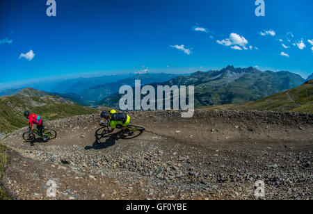Two mountain bikers ride a trail in the French ski resort of Méribel. Stock Photo