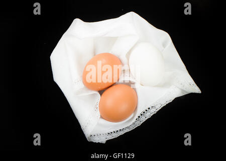 three chicken eggs on a black background Stock Photo