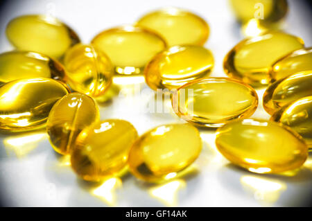 Some gold colored omega3 soft gel capsules. Stock Photo