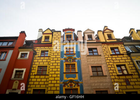 Tall, narrow houses with colourful facades line a street near the centre of Wroclaw, Poland. Stock Photo