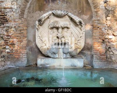 Old water spitting fountain in Rome, Italy Stock Photo