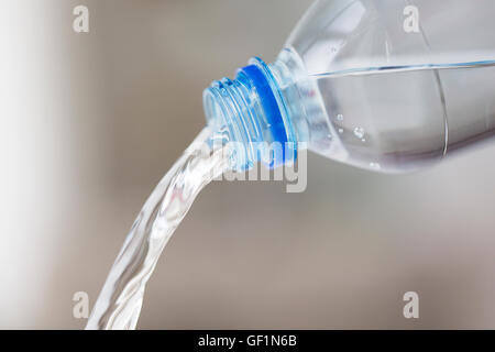 close up of water pouring from plastic bottle Stock Photo