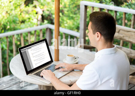 close up of businessman with laptop on terrace Stock Photo