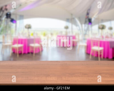 Wooden empty table in front of blurred restaurant Stock Photo