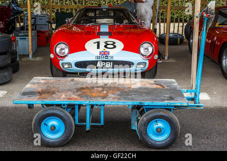 Empty tyre trolley parked in front of the 1963 Ferrari 250 GTO/64 in the paddock at the 2015 Goodwood Revival, Sussex, UK. Stock Photo
