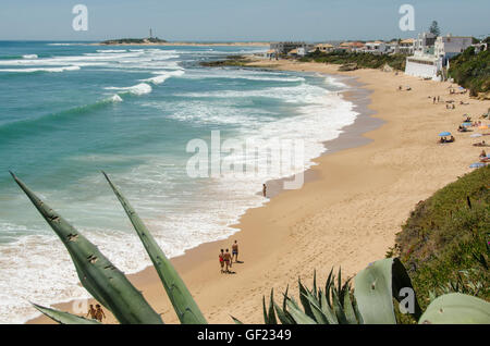 View of the beach in the small seaside town of Los Caños de Meca, in Cádiz province.  Cape Trafalgar and its lighthouse can be s Stock Photo