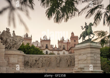 Partial view of the Plaza de España in the historic quarter of Cádiz, at sunset.   In the middle part of the image, the tops of Stock Photo
