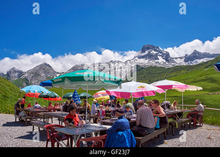 Restaurant terrace at Col des Annes with the Chaîne des Aravis beyond. Le Grand Bornand, Haute-Savoie, France. Stock Photo