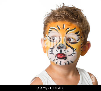 lovely boy child with face painting of a tiger or a lion Stock Photo