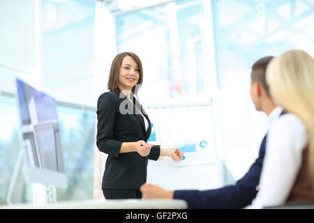 Businesswoman asking question during her colleagues presentation Stock Photo