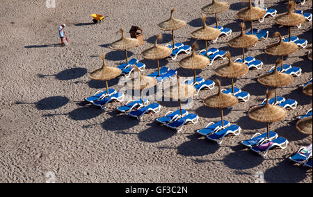 A man cleans the beach early in the morning, before bathers arrive, in Saint Elm, Mallorca, Spain Stock Photo