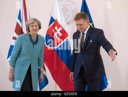 Bratislava, Slovakia. 28th July, 2016. British Prime Minister Theresa May, left, is welcomed by Slovak Prime Minister Robert Fico, right, ahead of their meeting in Bratislava, Slovakia, Thursday, July 28, 2016. Credit:  Martin Mikula/CTK Photo/Alamy Live News Stock Photo