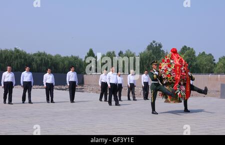 Tangshan, China's Hebei Province. 28th July, 2016. Chinese President Xi Jinping, who is also general secretary of the Communist Party of China (CPC) Central Committee and chairman of the Central Military Commission (CMC), visits a memorial to leave flowers and pay his respect to all those who died in the devastating earthquake and heroes sacrificed in the earthquake relief work at Tangshan Earthquake Memorial Park in Tangshan, north China's Hebei Province, July 28, 2016. Credit:  Lan Hongguang/Xinhua/Alamy Live News Stock Photo