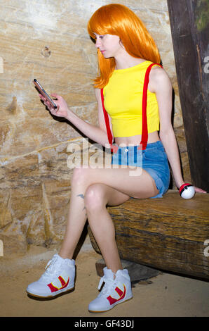 Sydney, Australia: 29th July 2016: Misty Pokemon Cosplay Photoshoot inspired by the release of the new game Pokemon Go. Pokemon Go is an app game that allows the player to catch Pokemon using virtual reality technology. Pictured is Becky, an Australian based cosplayer seen portraying the pokemon trainer Misty while enjoying the game around Cockatoo Island.   Credit:  mjmediabox / Alamy Live News Stock Photo