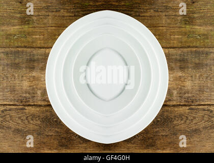 Empty white plate on wooden table Stock Photo