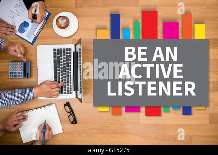 BE AN ACTIVE LISTENER Business team hands at work with financial reports and a laptop Stock Photo