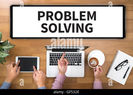 PROBLEM SOLVING Two Businessman working at office desk and using a digital touch screen tablet and use computer, top view Stock Photo