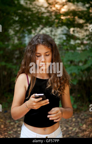 Girl texting with her mobile phone Stock Photo
