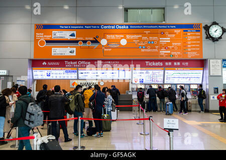 Japan, Kansai airport, KIX. Interior Aeroplaze transport hub. Nankai railways ticket area with passengers, some queueing for the ticket machines. Stock Photo