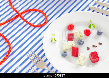 Appetizer made of beet, cottage cheese with fruits on sailing style decorated table. Stock Photo
