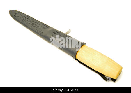 A wood handled carving knife in a black sheath on a white background. Stock Photo