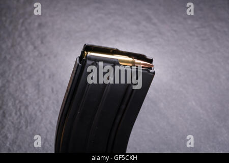 Loaded Ammunition in Magazine .223/556 on Slate Surface Stock Photo