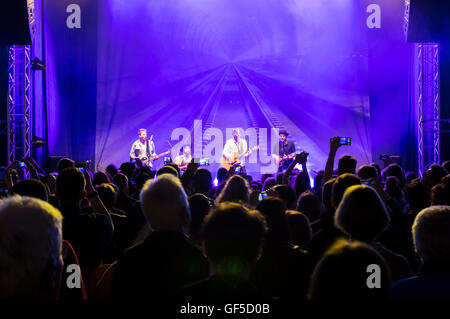 People taking mobile phone pictures of the Swiss folk rock group 77 Bombay Street performing at a concert. Stock Photo