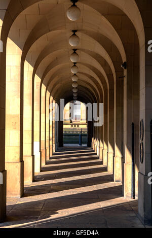 Sunlight coming through the arches forming shadows in columns. Stock Photo