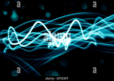 Blue swirly lines on black background Stock Photo