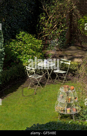 garden table and chairs on lawn in English Garden Stock Photo