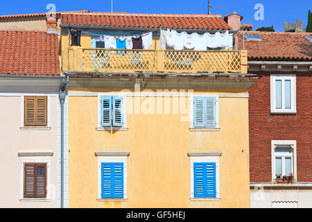 Drying laundry on a colorful house at Tartini Square in Piran, Slovenia Stock Photo
