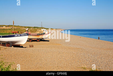 A view of inshore fishing boats and the shingle beach on the North Norfolk coast at Weybourne, Norfolk, England, United Kingdom. Stock Photo