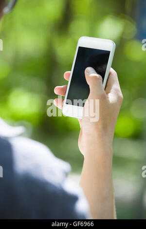Young Chinese man using smart phone Stock Photo