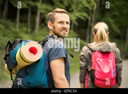 Walking couple or friends. Hikers in forest. Stock Photo