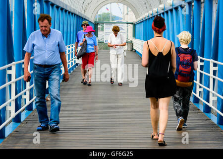 Goteborg, Sweden - July 25, 2016: Unknown people walking across an elevated public walkway. Focus on senior ladies coming toward Stock Photo