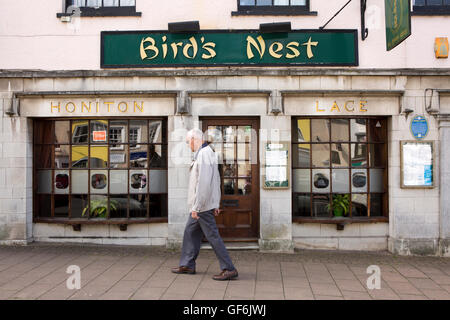 UK, England, Devon, Honiton, High Street, man walking past Birds Nest Chinese Restaurant in former Honiton Lace Shop Stock Photo