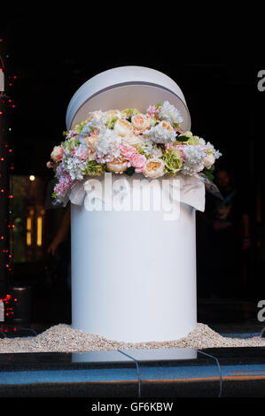 bouquet of white and pink flowers in cylinder Stock Photo