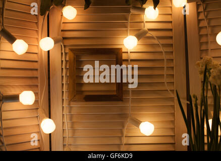 decorative bulbs and frame for photo in a wooden interior Stock Photo