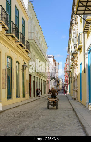 An old man cycles along the street in Old Havana (La Habana Vieja), Cuba Stock Photo
