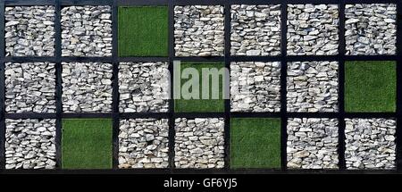 Square check pattern of grass and stone wall Stock Photo