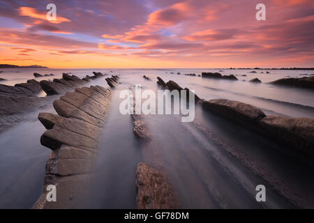 Amazing sunset over flysch geological formation in Sakoneta beach