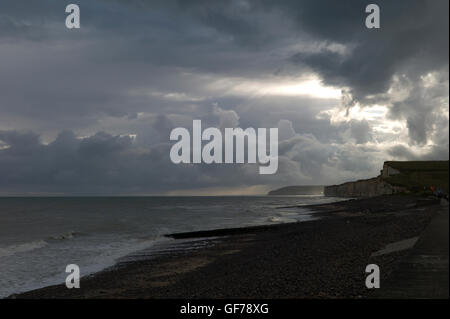Storm clouds and sun over cliffs, Normandy,France Stock Photo