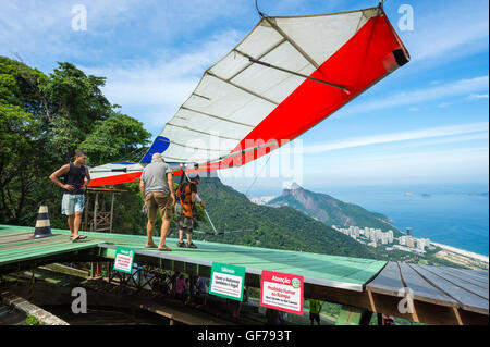 RIO DE JANEIRO - MARCH 22, 2016: A hang glider prepares to take off from the upper ramp at Pedra Bonita, in the Tijuca Forest. Stock Photo