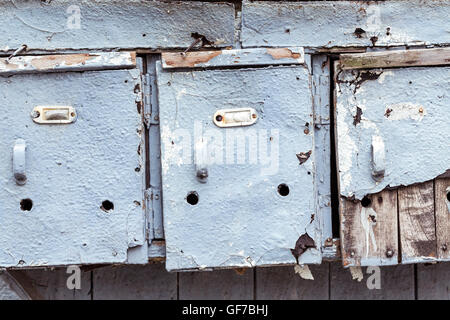 three very old and grungy mailboxes Stock Photo